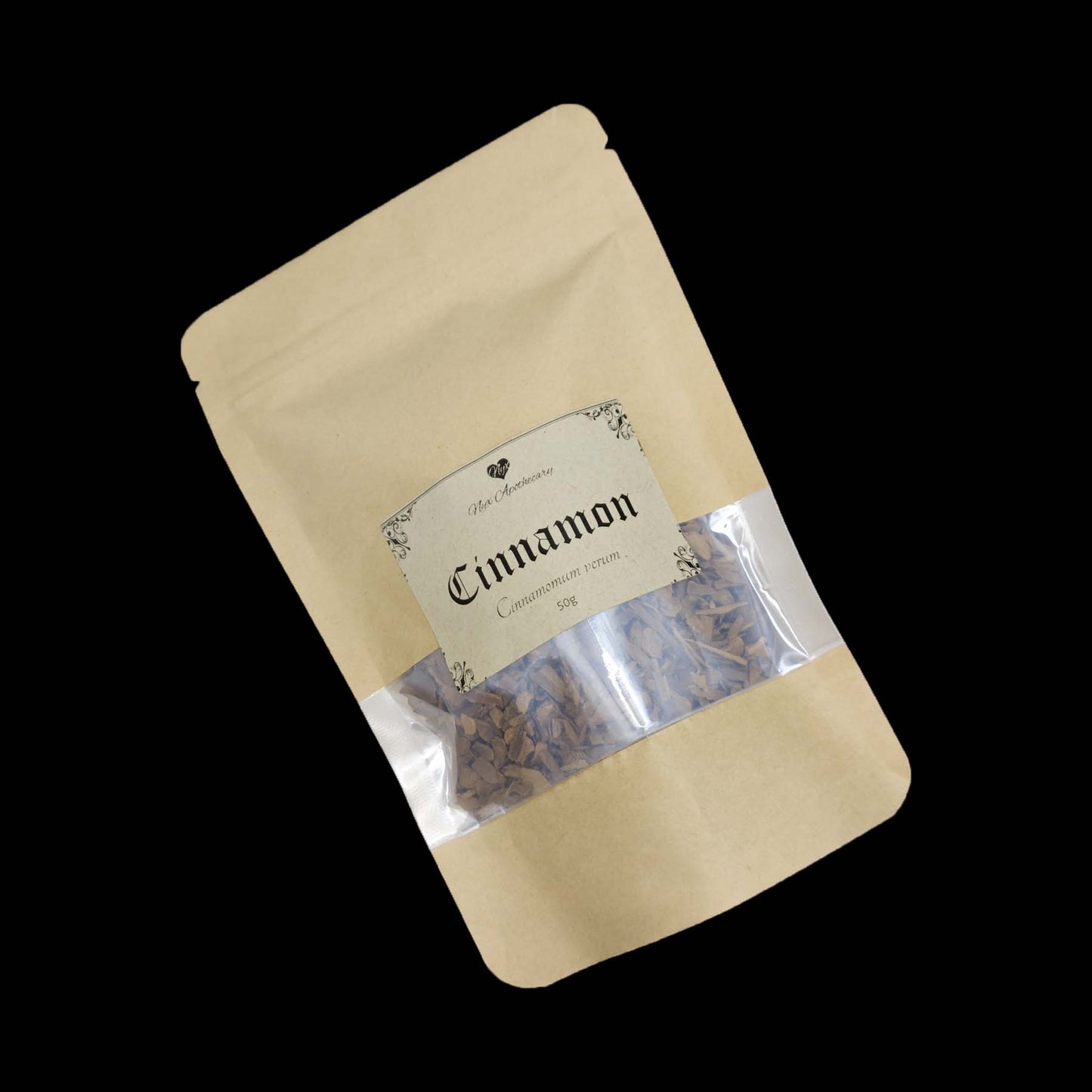A kraft bag labelled Cinnamon with a clear window showing the contents.