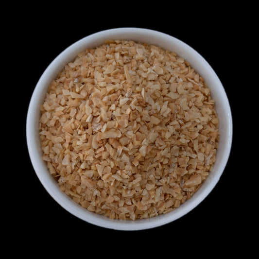 A small white bowl filled with garlic granules