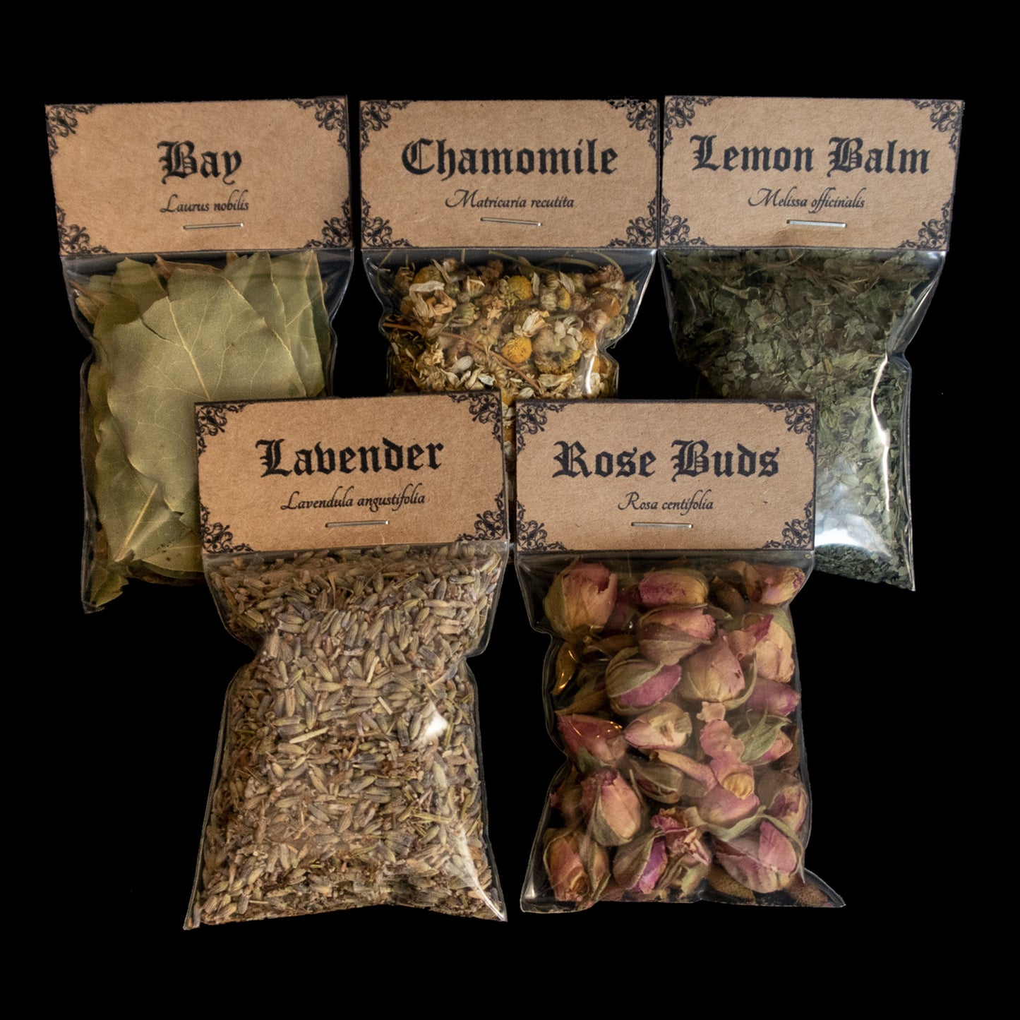 A collection of 5 bags of herbs - Victorian-apothecary-style brown labels at the top give the common and Latin names