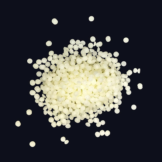 a pile of small, round white beeswax pellets