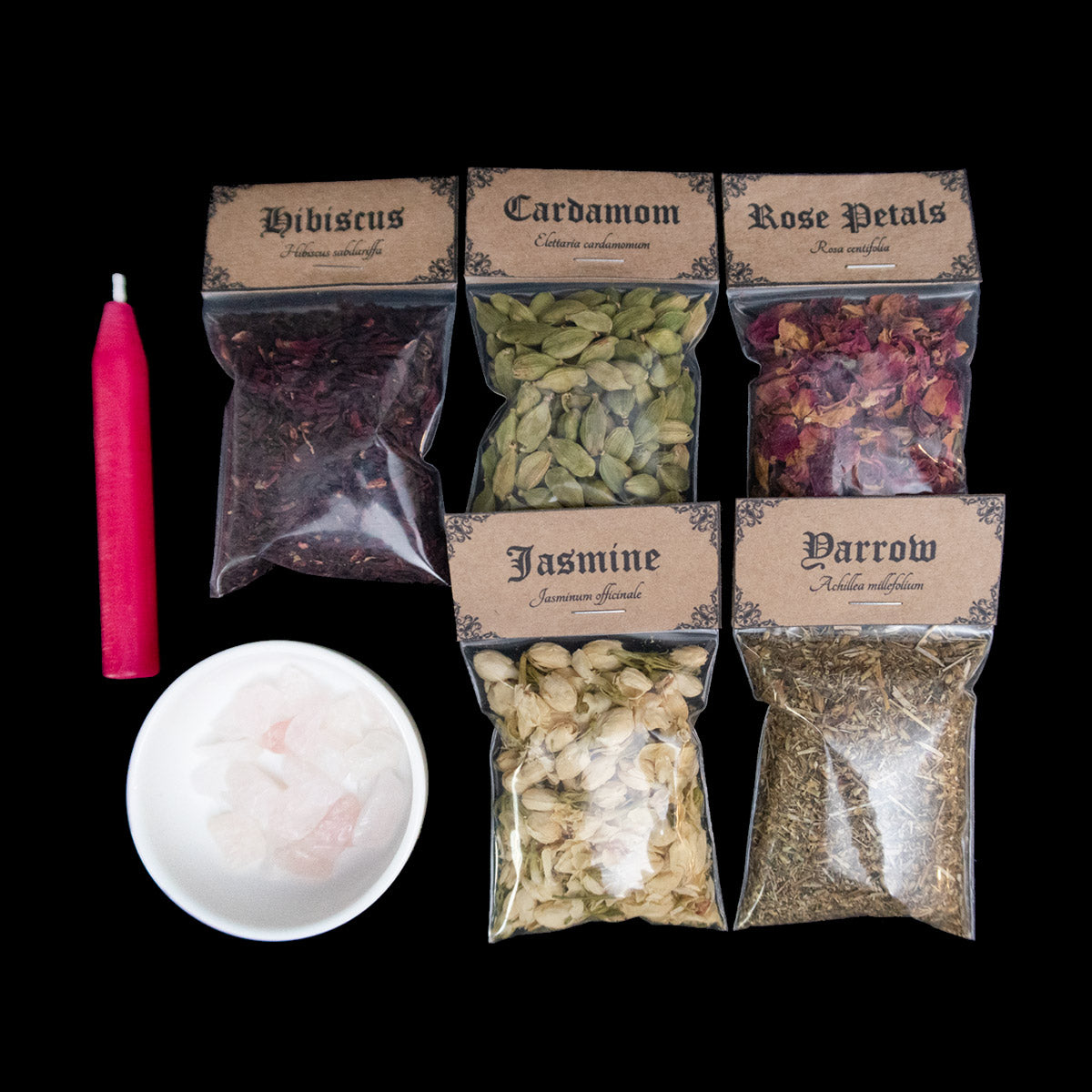 A pink chime candle, small bowl of large rose quartz crystal chips, and 5 bags of herbs with Victorian-apothecary-style brown labels at the top give the common and Latin names