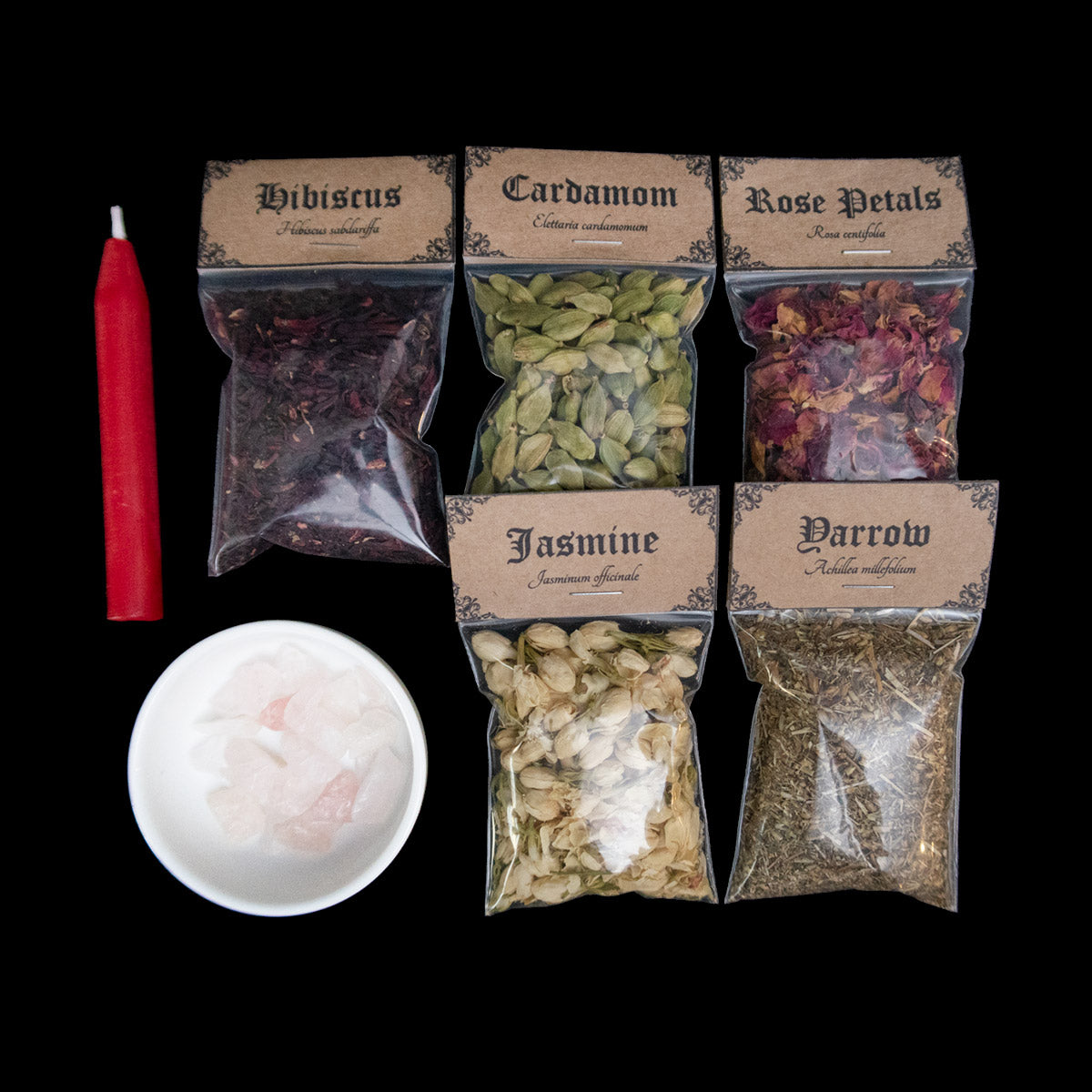 A red chime candle, small bowl of large rose quartz crystal chips, and 5 bags of herbs with Victorian-apothecary-style brown labels at the top give the common and Latin names