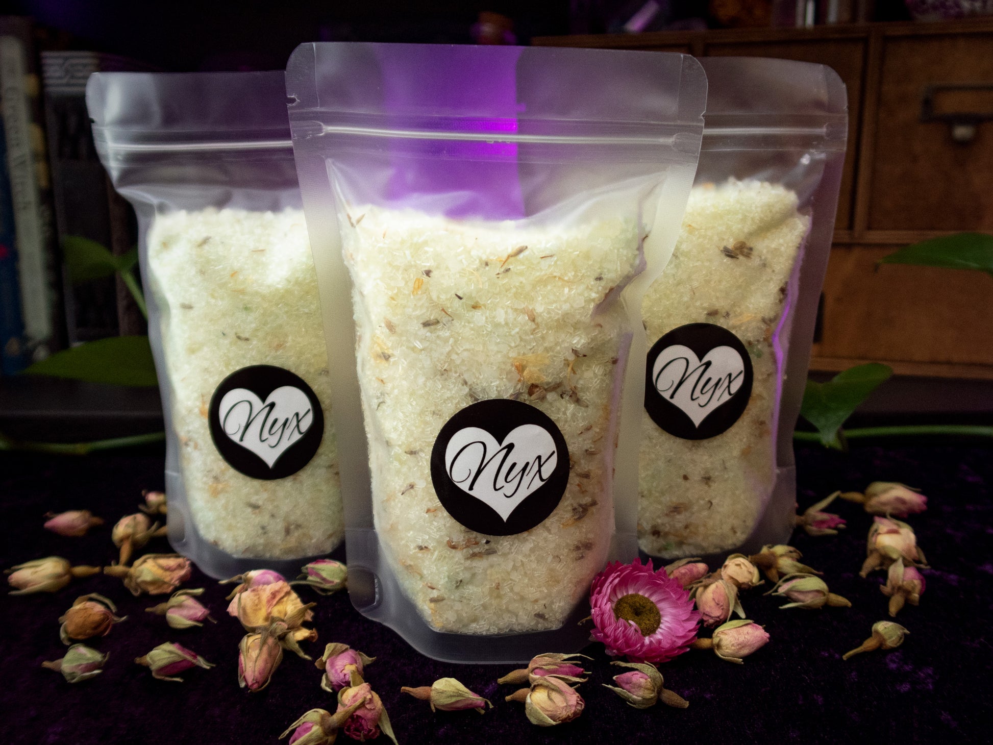 3 clear/frosted bags filled with green bath salts with botanicals