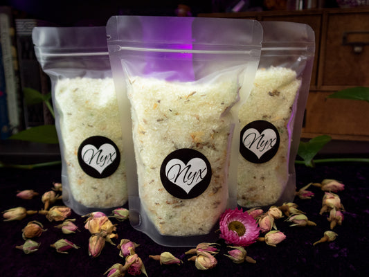 3 clear/frosted bags filled with green bath salts with botanicals